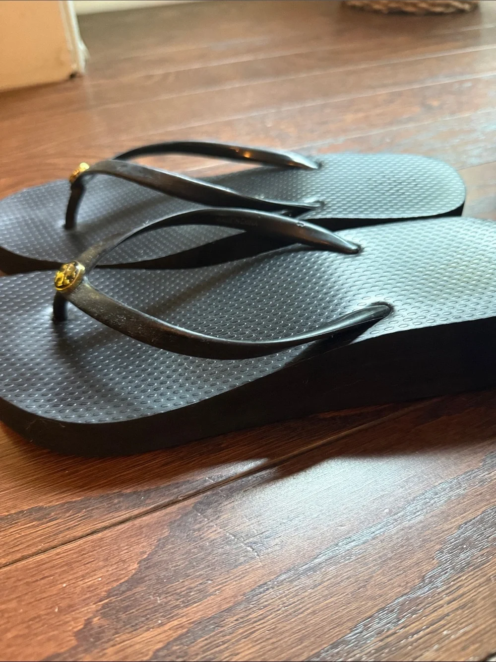 Tory Burch Black Flip Flop Sandals with Gold Logo Medallion